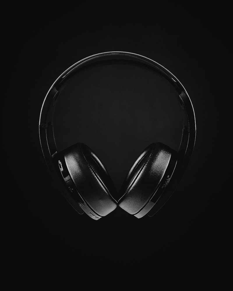 Headphones from above on a dark surface