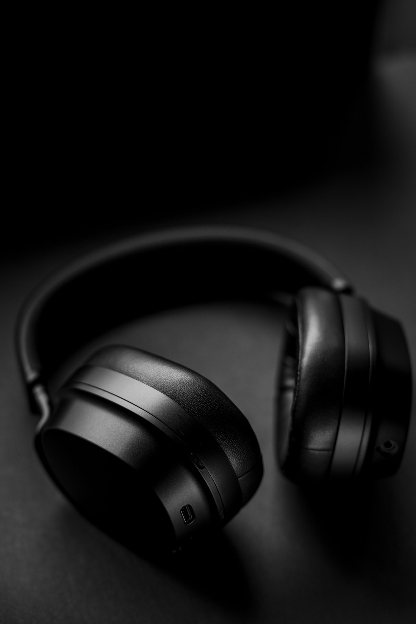 SG-01 Headphones, ear cup detail on a black surface