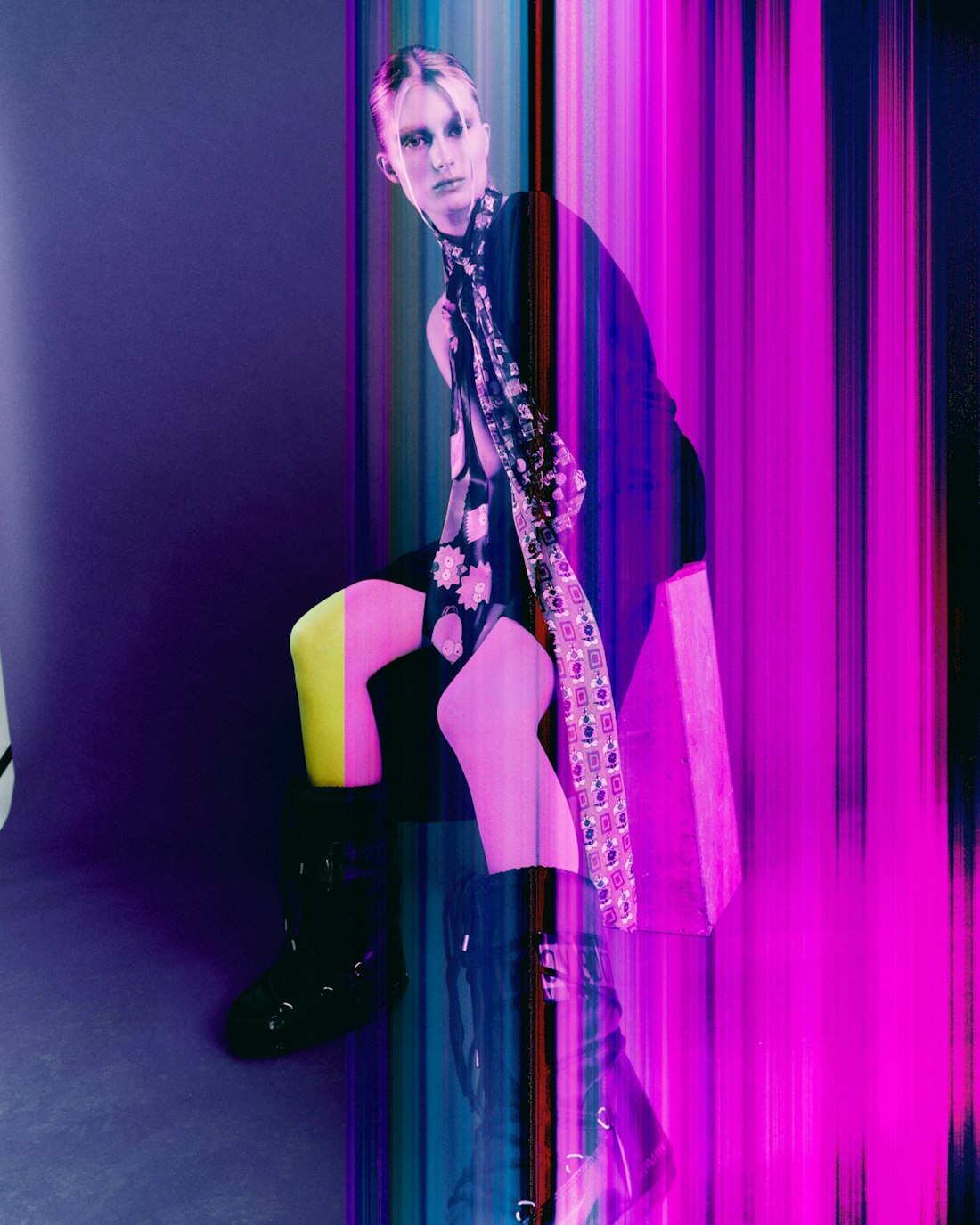Model in black with a neon accent against light streaks